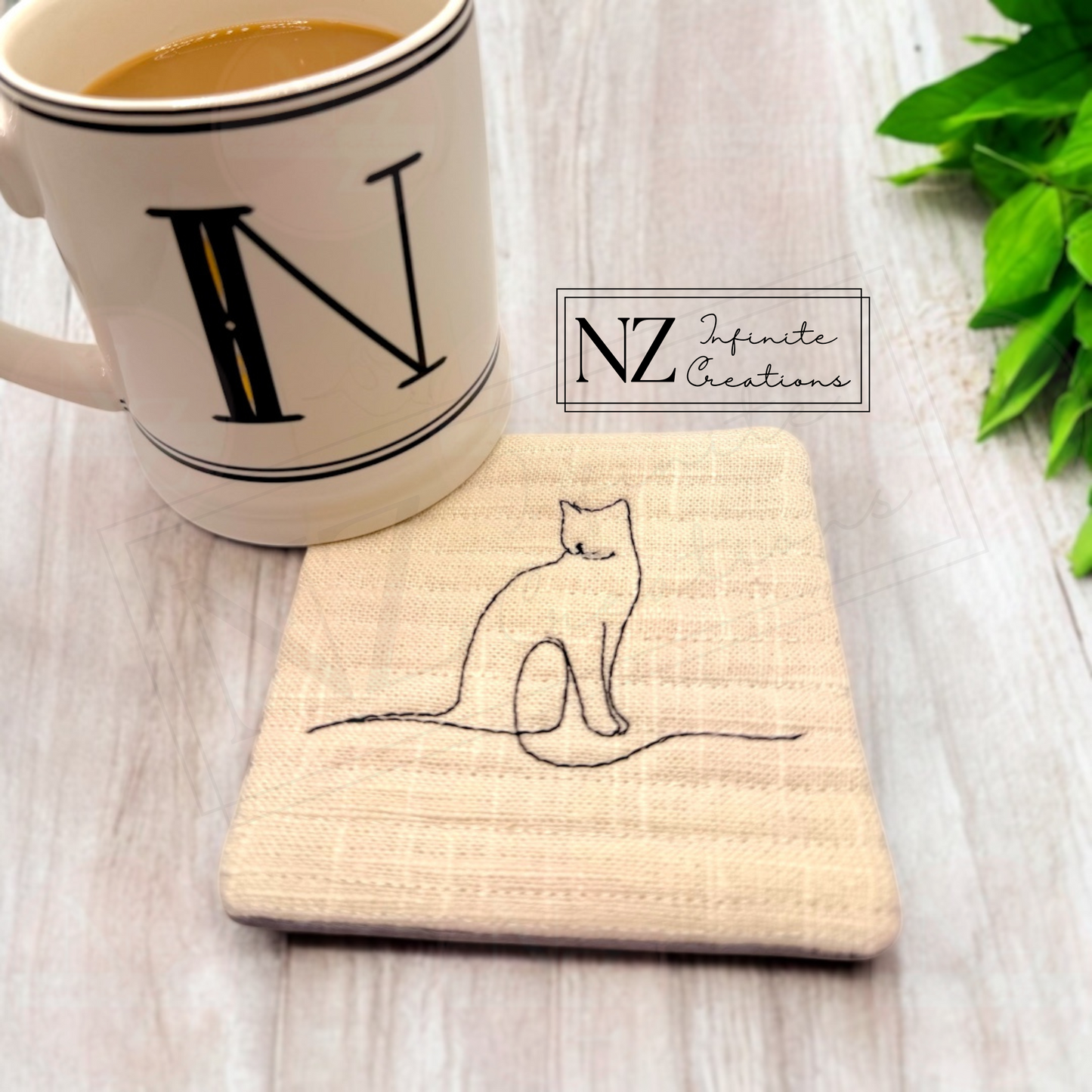 Cat Line Art Mug Rug featuring an embroidered minimalist cat design. Made from linen fabric and batting, this 4.25" by 4.25" mug rug is perfect for cat lovers to protect surfaces while enjoying their favorite drink.