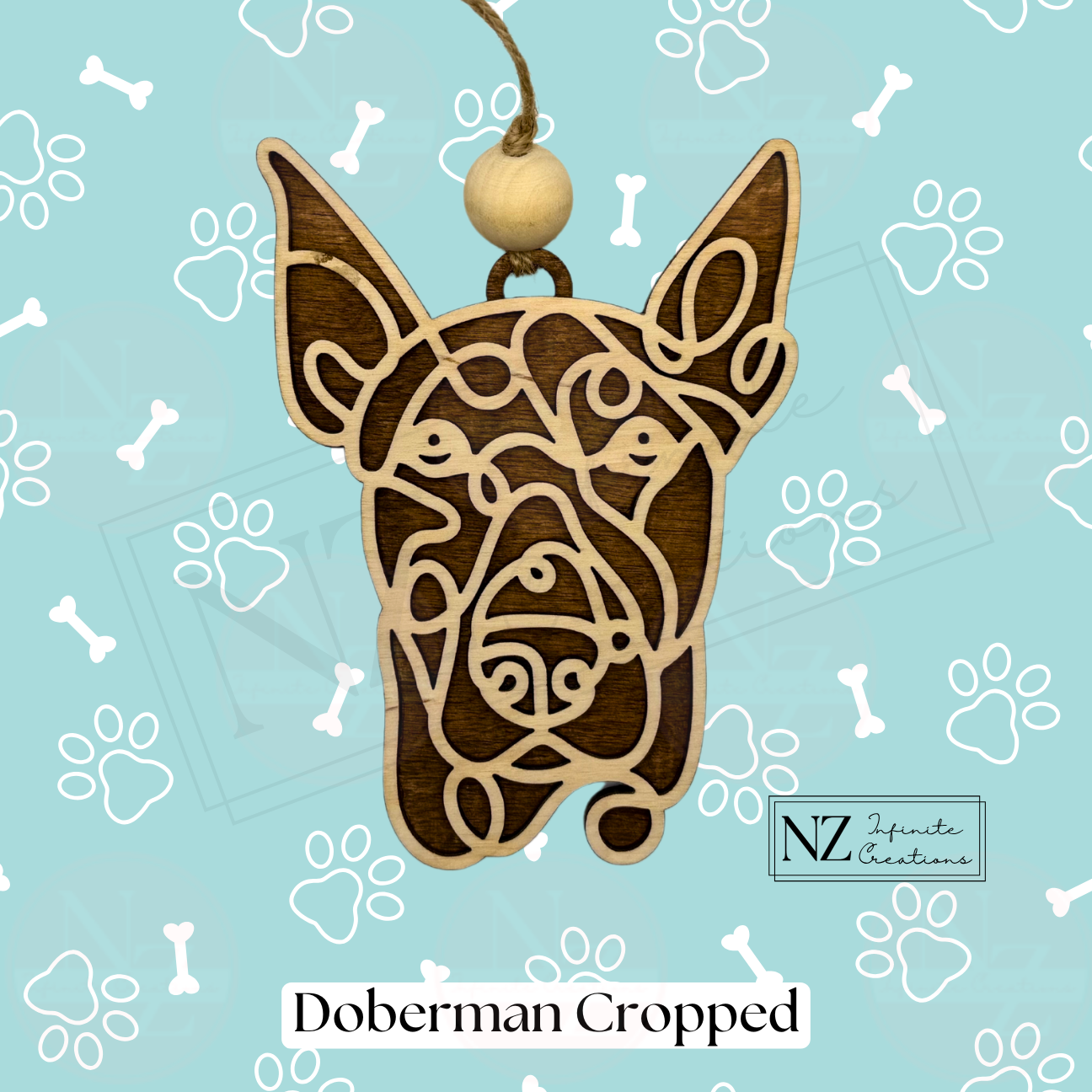 Doberman Line Art Ornament made from wood with a laser-engraved design. Includes twine and a wooden bead for easy hanging. A perfect gift for Doberman lovers and a striking addition to holiday decor or dog-themed collections.